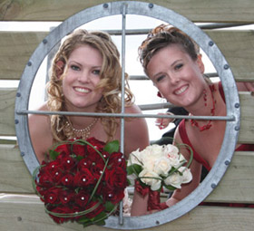 Bride and bridesmaid framed by port hole